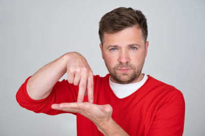 Portrait of young man against white background