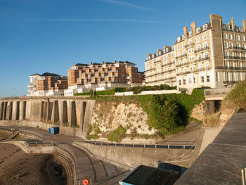 Buildings against clear blue sky in city