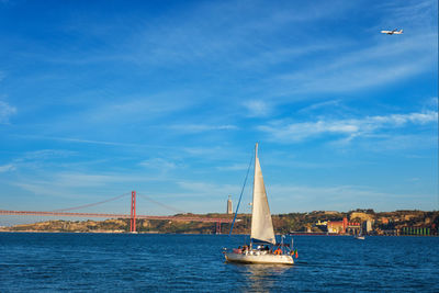 Sailboat sailing on sea against sky