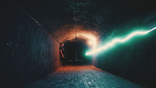 Man in illuminated tunnel