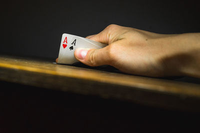 Close-up of hand holding cards