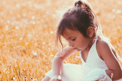 Girl sitting on field