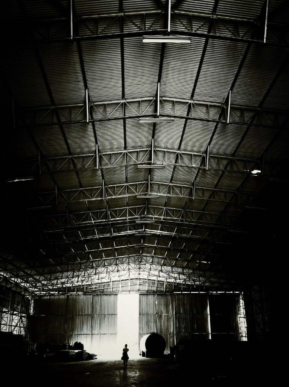 indoors, ceiling, built structure, illuminated, architecture, pattern, lighting equipment, night, interior, transportation, in a row, incidental people, window, silhouette, metal, dark, wall - building feature, men, empty