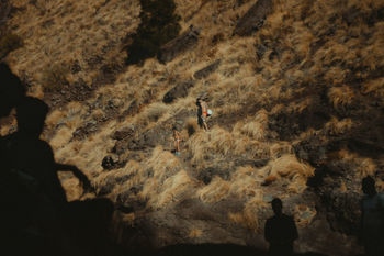 SHADOW OF MAN ON ROCK AT MOUNTAIN