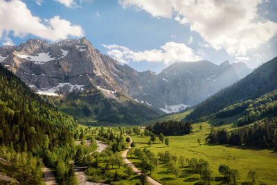 Scenic view of field and mountains against sky