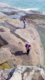 High angle view of woman on rocks at shore
