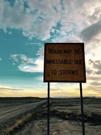 Road sign against sky