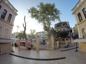 Statue in city against sky