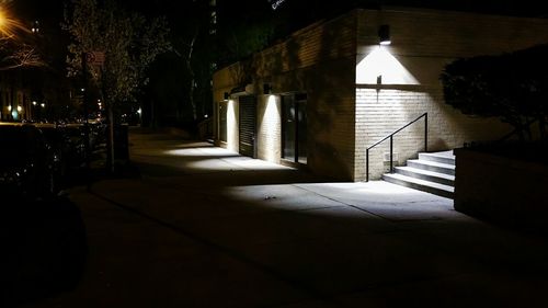 Illuminated walkway at night