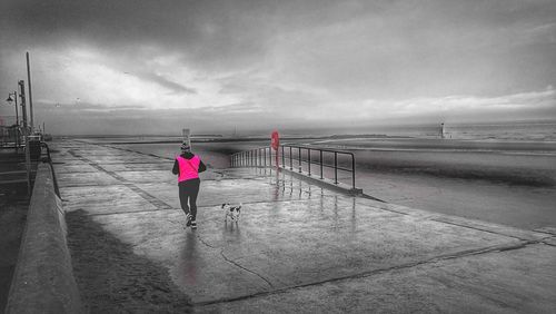 Pier on beach against sky