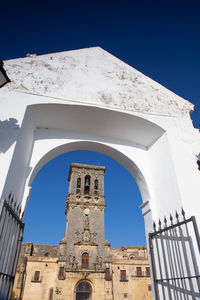 Low angle view of historic building against clear blue sky