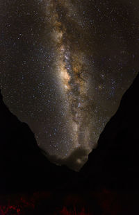 Silhouette mountain against sky at night