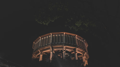 Low angle view of illuminated building against sky at night