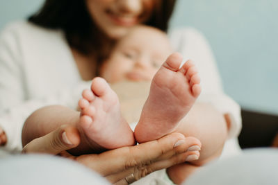 Health insurance for newborn babies. life insurance for new baby. mother holding in hands feet of