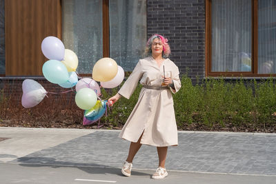 Full length of woman with balloons