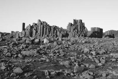 View of buildings and rocks against clear sky