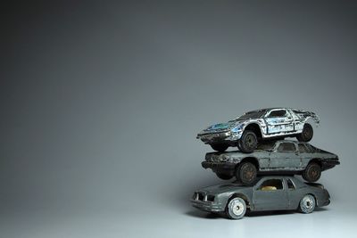 Close-up of toy car over gray background