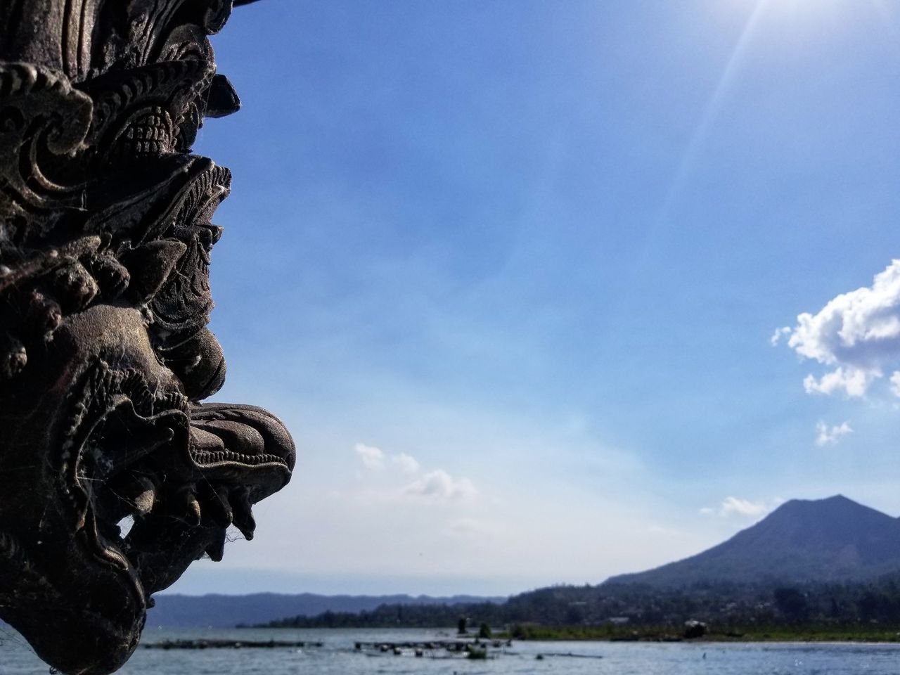 SCULPTURE OF STATUE AGAINST CLOUDY SKY