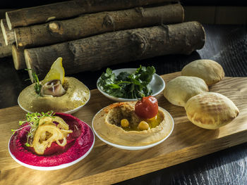 Hummus with bread on cutting board