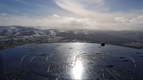 Aerial view of sea and mountains against sky