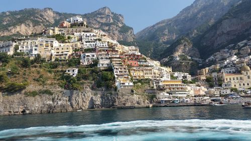 Houses on mountain at shore in positano