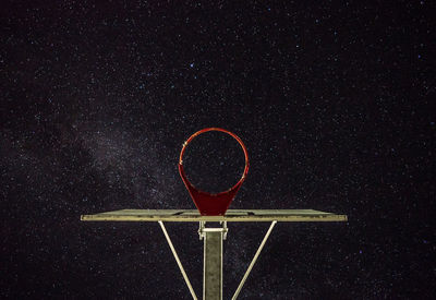 Low angle view of basketball hoop against sky at night