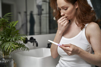 Young woman using mobile phone at home