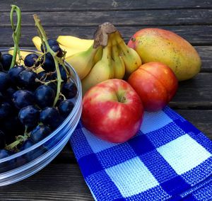 High angle view of fruits and napkin on wooden table