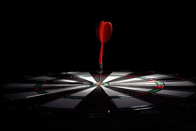 Close-up of illuminated lighting equipment against black background