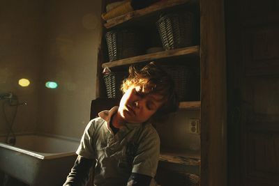 Portrait of boy sitting at home