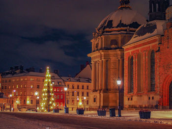 Illuminated building against sky at night