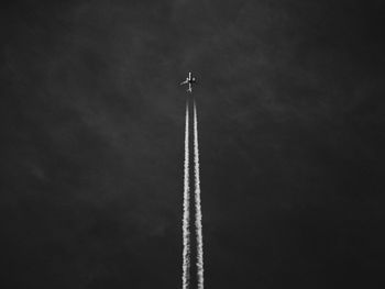 Low angle view of airplane flying against sky