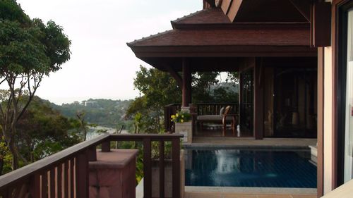 View of swimming pool by building against sky