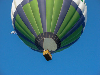 Low angle view of hot air balloon against clear blue sky