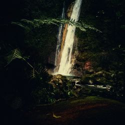 Scenic view of waterfall at night