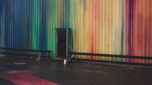 Open door on colorful industrial wall