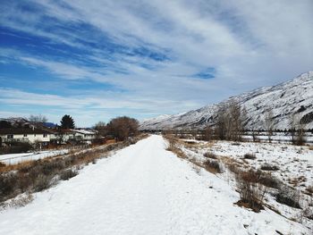 Snow covered road against sky