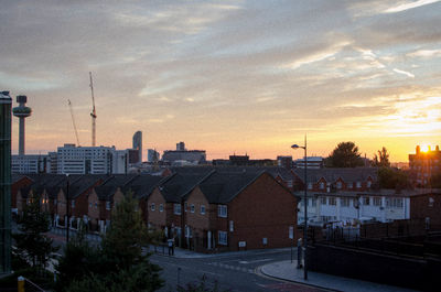 View of cityscape against cloudy sky