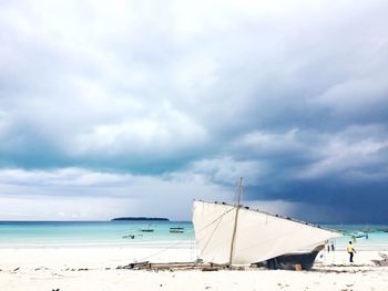 Sailboat on beach against sky