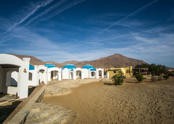 Built structure on beach against blue sky