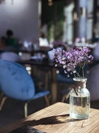 Close-up of purple flower vase on table