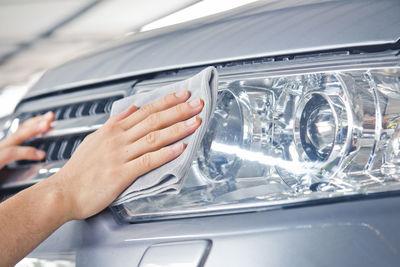 Close-up of hand on glass car