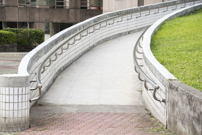 Footpath by railing in city