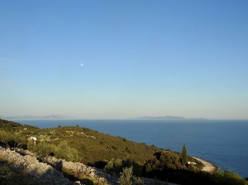 Scenic view of sea against clear blue sky