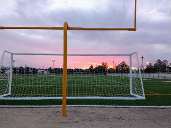 Soccer field against cloudy sky