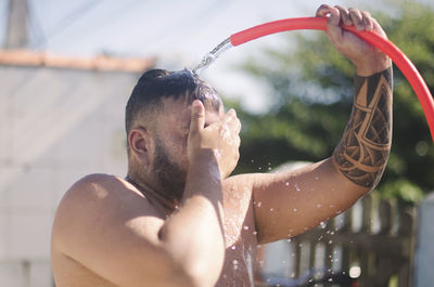 Full length of shirtless man in water