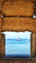 Boats in sea against sky