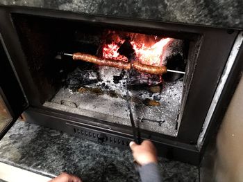 High angle view of person preparing food on barbecue grill