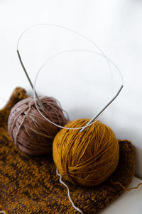 Close-up of yarn on table against white background