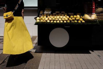 Rear view of woman standing at market stall